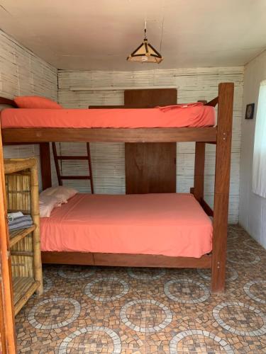 a bedroom with two bunk beds in a room at Wiracocha Hostal Máncora - Surf Camp in Máncora