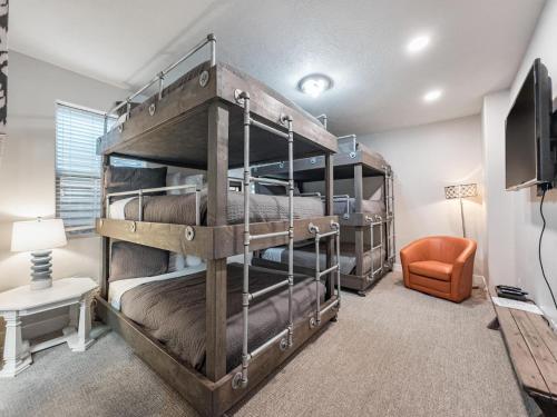 two bunk beds in a room with a tv at 3| Grand View Estate in St George with Views and Lawn in Santa Clara