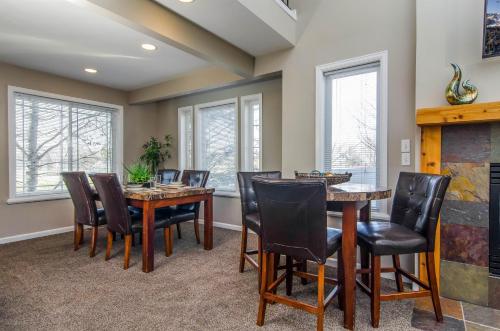 a dining room with a table and chairs and windows at Union Cove in Salt Lake with Secluded Privacy in Midvale