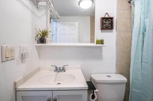 a white bathroom with a sink and a toilet at San Francisco Apartment about 5 Mi to Downtown! in San Francisco