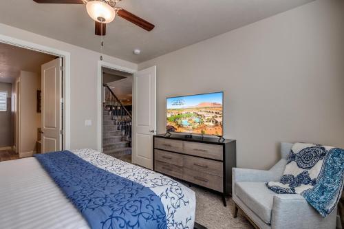 a bedroom with a bed and a flat screen tv at 85| Southern Comfort in St George with Hot Tub in Santa Clara