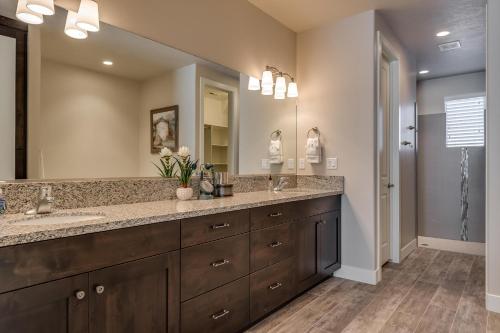 a bathroom with two sinks and a large mirror at 85| Southern Comfort in St George with Hot Tub in Santa Clara