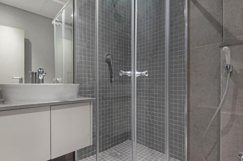 a bathroom with a shower and a sink at 707 at 2SIX2 Florida Road by HostAgents in Durban