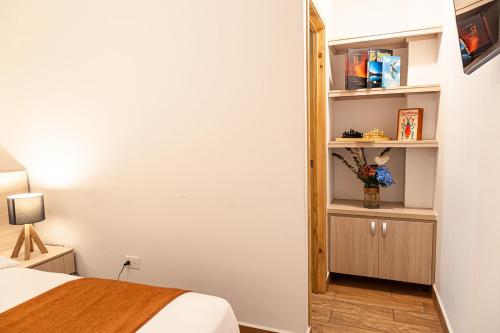 a bedroom with a bed and a book shelf at Hotel Mirador de Boquia Salento in Salento
