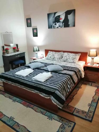 a bedroom with a large bed with pillows on it at Villa Paradisos in Likóstomon