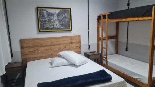 a bedroom with two bunk beds and a ladder at Pousada Central in Bragança Paulista