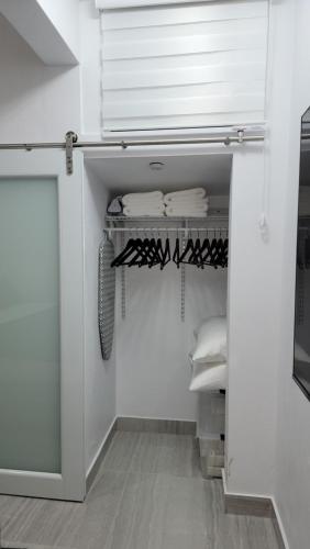 a walk in closet with white walls and a door at The Yellow Spot in Fajardo