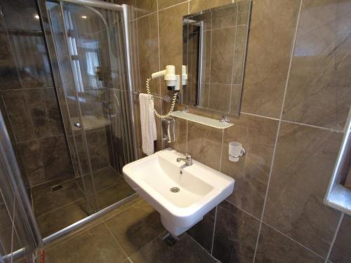 a bathroom with a sink and a shower at oscar garden hotel in Antalya