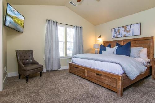 a bedroom with a bed and a chair and a window at Urban Central in Salt Lake with Indoor Hot Tub in Salt Lake City