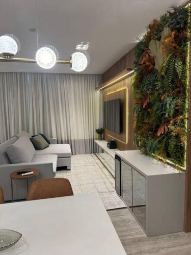 a living room with a couch and a tv at Infinity Tower Flat - 1403 in Itapema
