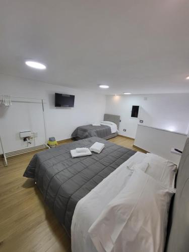 a bedroom with two beds and a chalkboard in a room at L'Approdo di Dante in Naples