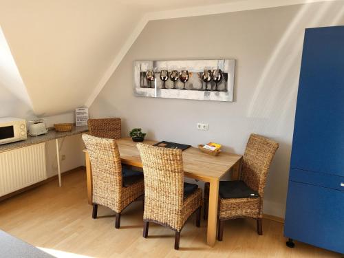 - une salle à manger avec une table et des chaises en bois dans l'établissement Ferienwohnung Gästehaus Bauer, à Heiligenhaus