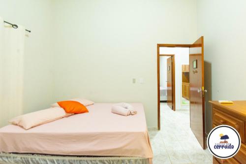 a bedroom with a bed and a mirror at Pousada Cantos do Cerrado in Chapada dos Guimarães