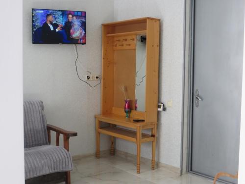 a room with a table and a mirror and a chair at Guesthouse Bacha & Lia in Mestia