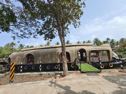 an old train car parked next to a tree at SR Houseboats Kumarakom in Kumarakom
