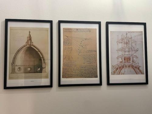 three framed pictures of a building and a ship on a wall at Casa Mozza vicino Firenze in Sesto Fiorentino