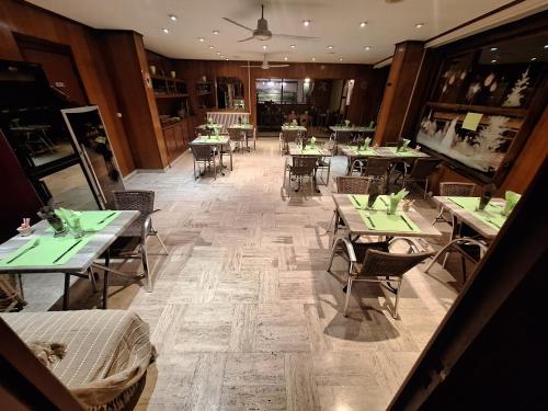 a restaurant with tables and chairs in a room at Hotel Au Bon Sejour in Vitry-le-François