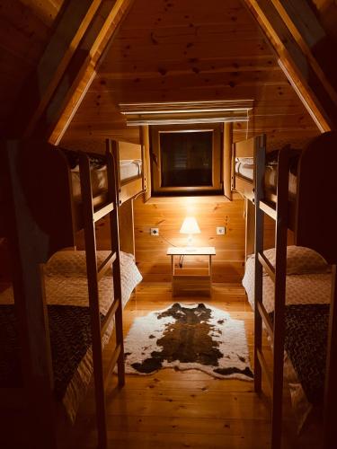 a room with two bunk beds and a tv at Guest House LENA in Žabljak