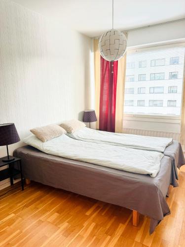 a large bed in a room with a window at Turku Downtown Cozy Flat with balcony 45m2 in Turku