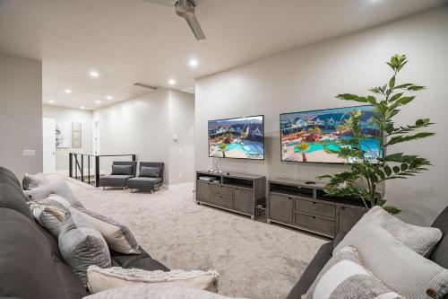 a living room with a couch and a flat screen tv at 30 | Poolhouse at Ocotillo Springs with Private Pool and Views in Santa Clara