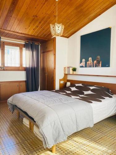 a bedroom with a large bed in a room at Maison Palamos La Fosca in Palamós