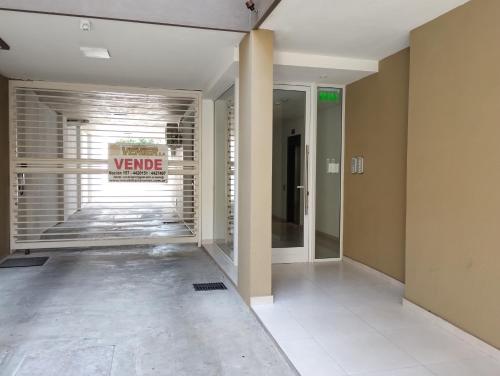 a hallway of a building with a sign on the wall at Departamento Céntrico amplió- Amueblado - PB- SIN WIFI in San Nicolás de los Arroyos