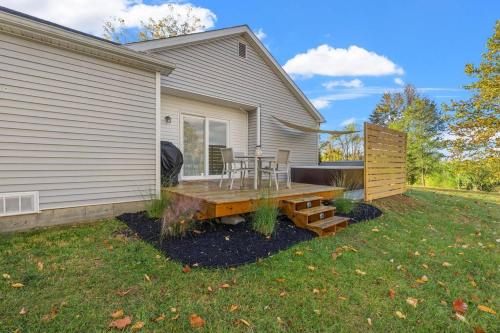 a backyard with a wooden table and a bench at The Luxe/ Hot Tub/ On Bright Leaf Golf Course in Harrodsburg