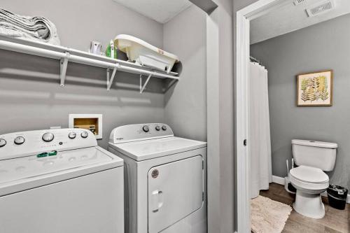 a white laundry room with a washer and dryer at The Luxe/ Hot Tub/ On Bright Leaf Golf Course in Harrodsburg