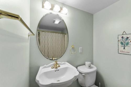 a white bathroom with a sink and a mirror at The Grey Goose in Duck