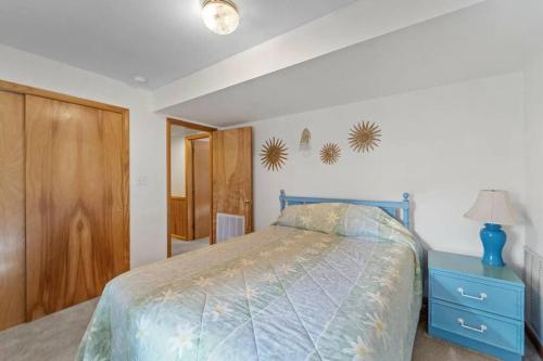 a bedroom with a bed and a blue dresser at The Grey Goose in Duck