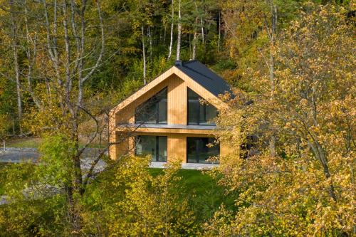 a house with a roof on top of a forest at Forest Inn Berest in Berest