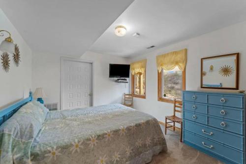a bedroom with a blue bed and a blue dresser at The Grey Goose in Duck