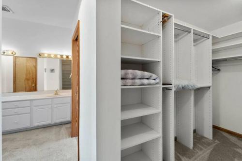 a bathroom with a closet with white shelves at The Grey Goose in Duck