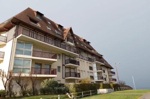 an apartment building with balconies and a roof at Apartment with balcony close to the beach in Cabourg