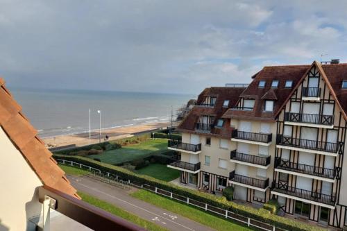 a view of a building and the beach at Apartment with balcony close to the beach in Cabourg