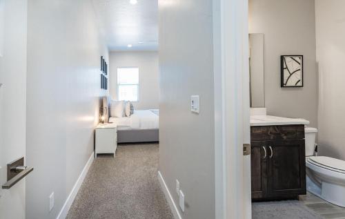 a bathroom with a toilet and a bed at 13| Red Mountain View in St. George with Private Hot Tub in Santa Clara