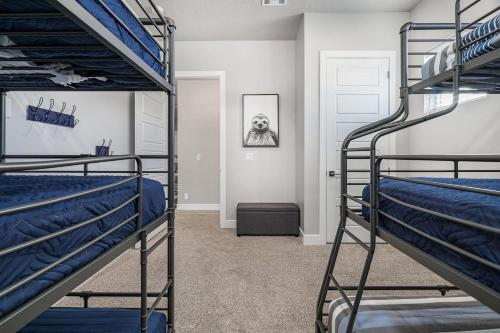 a bedroom with two bunk beds and a doorway at 13| Red Mountain View in St. George with Private Hot Tub in Santa Clara