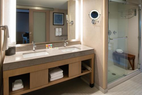 a bathroom with two sinks and a shower at Hyatt Place Chicago Wicker Park in Chicago