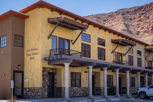 a building with a mountain in the background at Luxury Downtown Rental - La Dolce Vita Villas #2 in Moab
