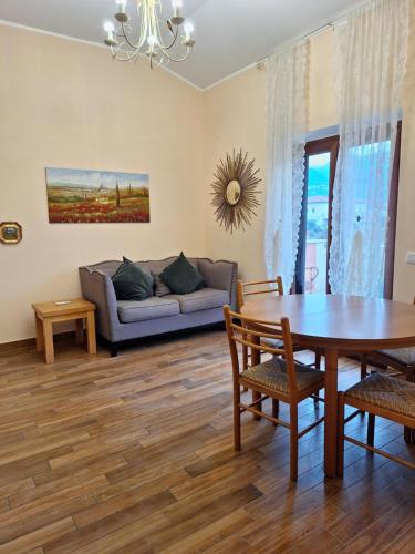 a living room with a table and a couch at Villa Corte at Via Roma - Apartments with a View in Villa Latina
