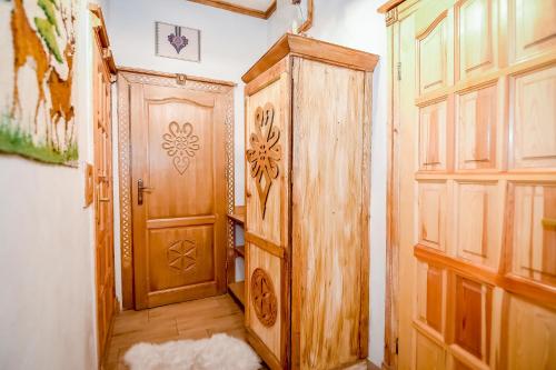 a room with a wooden door and a room with a floor at Domek u Zosi in Zakopane