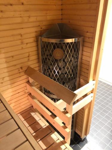 a bird house with a bench in it at Brand New and Cozy Modern Studio! WithAirCondition in Turku