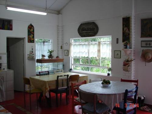 een keuken en eetkamer met een tafel en stoelen bij Ecopousada João Y Maria in Catuçaba