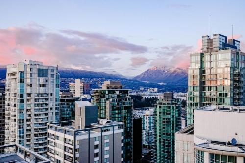 a view of a city with buildings and mountains at Blue Horizon Hotel in Vancouver