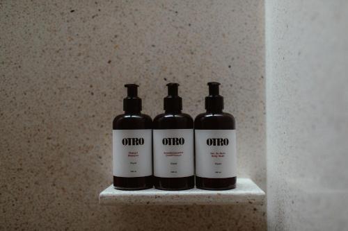 three bottles of wine sitting on a shelf at Otro Oaxaca, a Member of Design Hotels in Oaxaca City