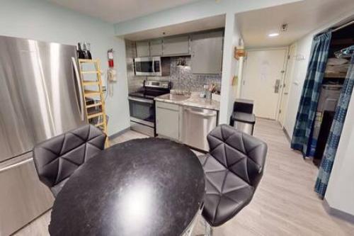 a kitchen with a table and chairs in a room at Workspace Studio Ski In Ski Out in Snowshoe