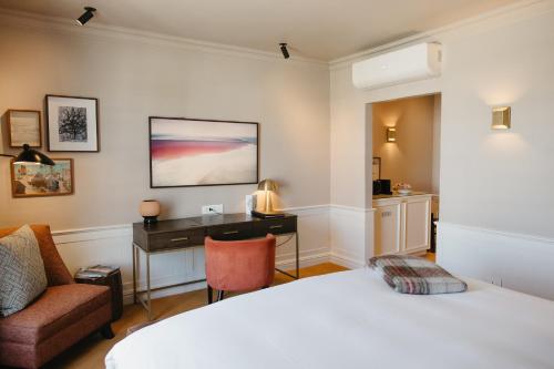 a hotel room with a bed and a desk at Erinvale Estate Hotel & Spa in Somerset West