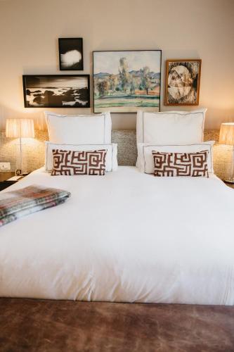 a bedroom with a large white bed with pillows at Erinvale Estate Hotel & Spa in Somerset West