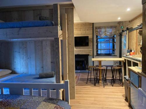 a bedroom with two bunk beds and a living room at The Snug in Matlock