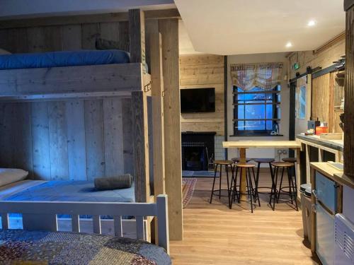 a bedroom with two bunk beds and a living room at The Snug in Matlock